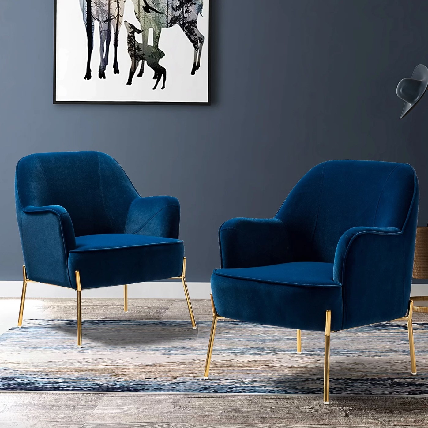the set of two velvet armchairs in navy with gold legs