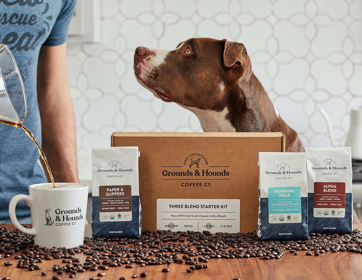 Coffee beans and coffee packaging with a model pouring coffee and a dog