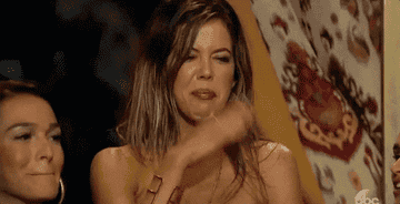 Someone fanning their face with their hand because of a stinky smell