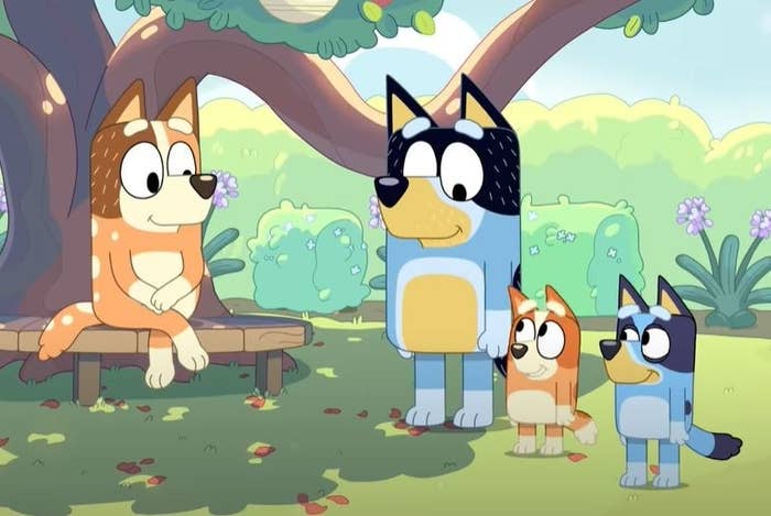 animated dog parents and dog kids smile while sitting in the woods