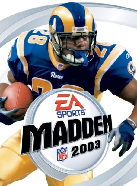 Marshall Faulk in a St. Louis Rams uniform while running with a football