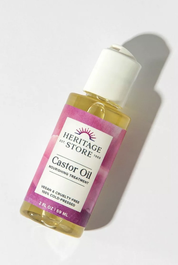 a bottle of castor oil with pink packaging