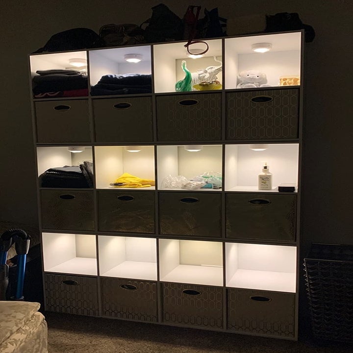 a reviewer photo of a cube storage unit with the light installed in each compartment 