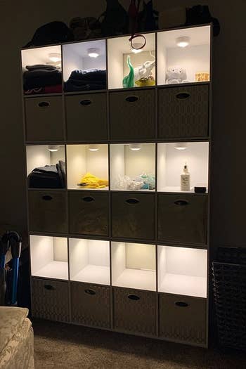 a reviewer photo of a cube storage unit with the light installed in each compartment 