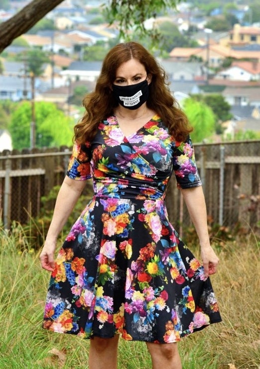 A reviewer wearing a floral dress