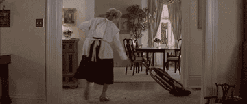 Gif of Robin Williams as Mrs. Doubtfire vacuuming and dancing