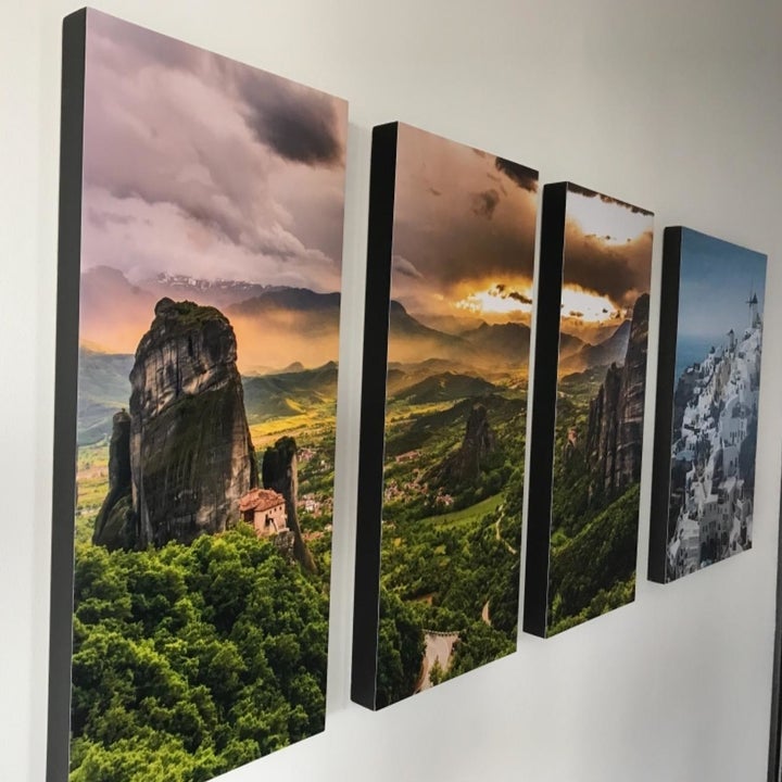 a reviewer photo of four canvases mounted on the wall