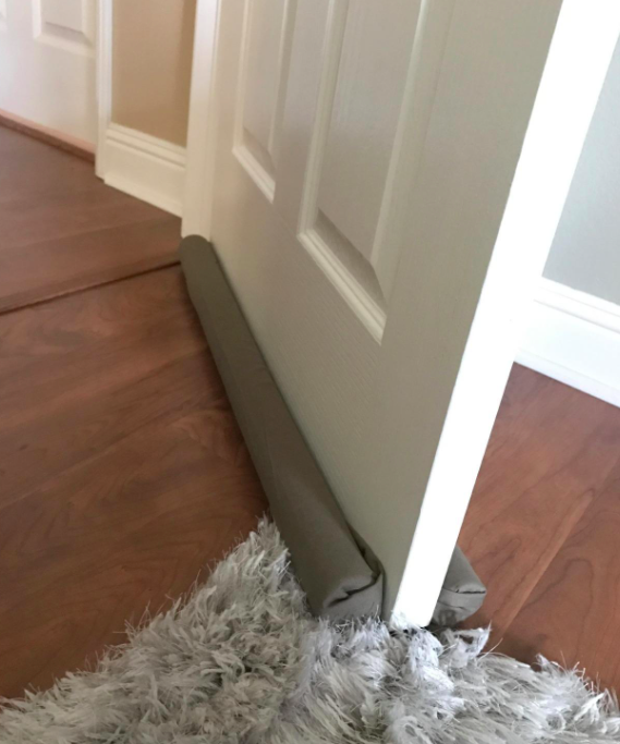 A customer review photo of the draft stopper on their door