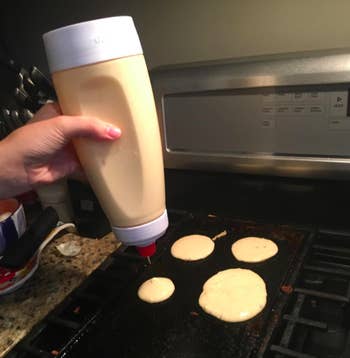 A customer review photo of them pouring out batter from the Whiskware Pancake Batter Mixer