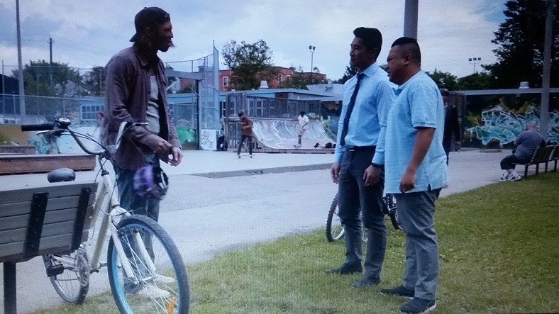 Jung and Kimchee confront the guy with Shannon's bike who is standing next to it and holding Shannon's purple helmet in his hand