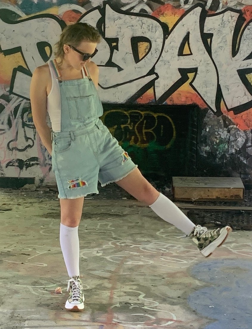 A person wearing the short overalls