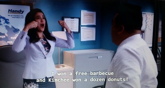 Shannon ecstatically pumps her fists after she and Kimchee won a free barbecue and a dozen donuts, respectively