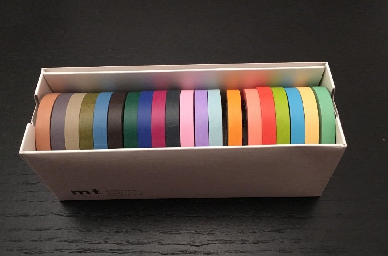 a reviewer photo of the box of tape with different-colored rolls