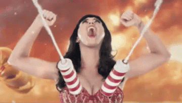 Katy Perry cheers while whipped cream shoots out of her breasts