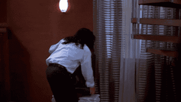 Tommy Wiseau throwing his tv out the window in a gif from the movie The Room 