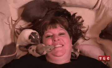 Person in bed with rats crawling on them 