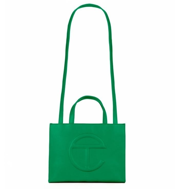 tote bag made of green faux leather with the brand's e-shaped logo on the front and a long handle for wearing across the shoulder plus regular wrist handles