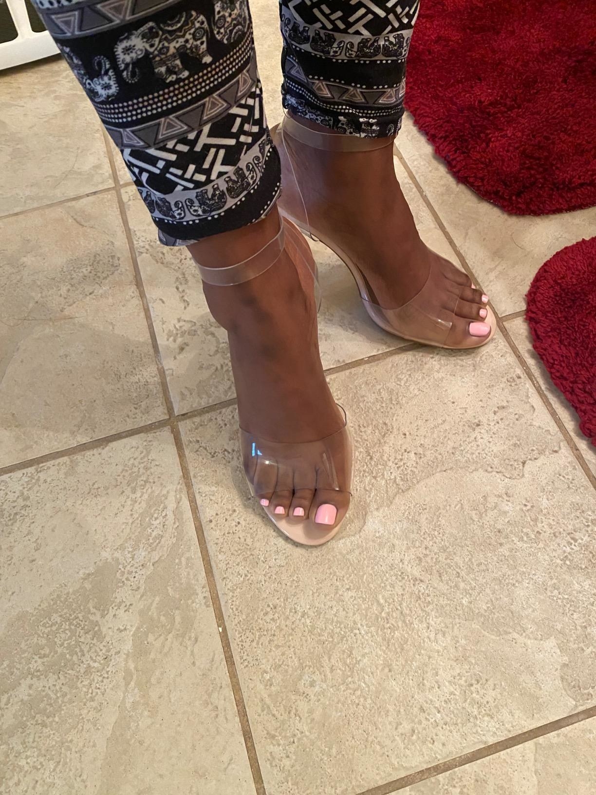 A customer showing off the clear strappy sandal