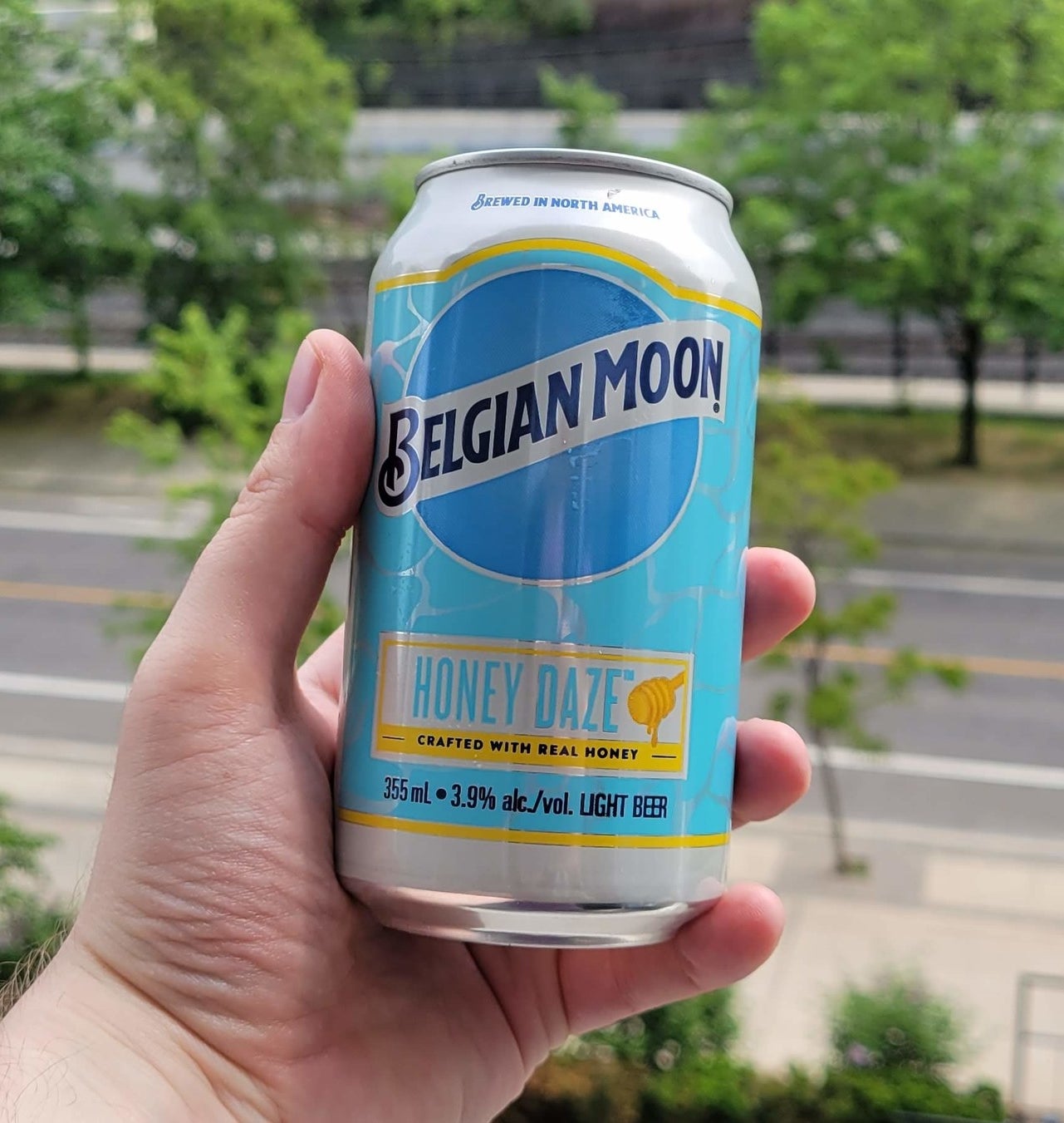 A can of Belgian Moon being held in a hand.