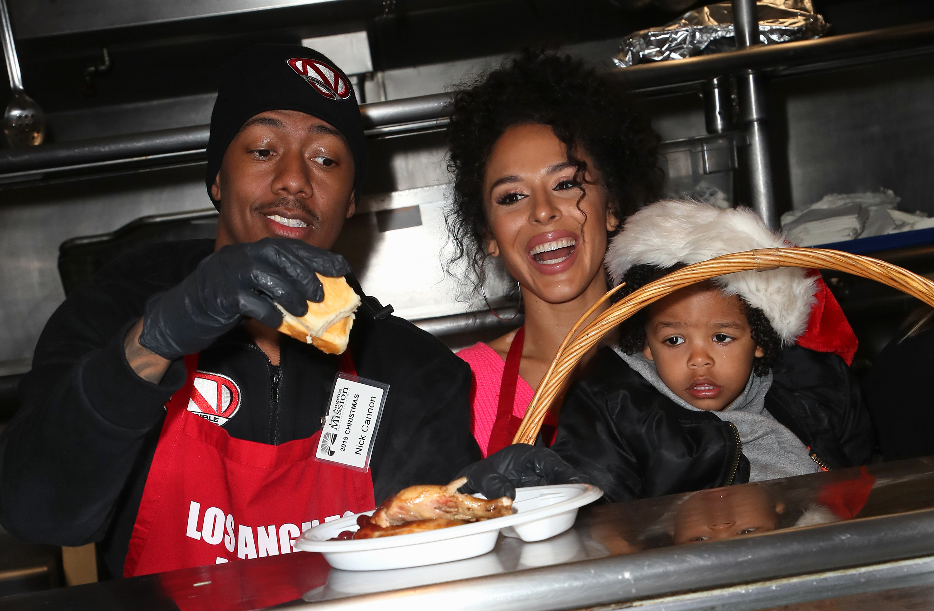 Nick Cannon, Brittany Bell, and their son Golden Cannon attend Christmas Celebration on Skid Row at the Los Angeles Mission on December 23, 2019, in Los Angeles, California