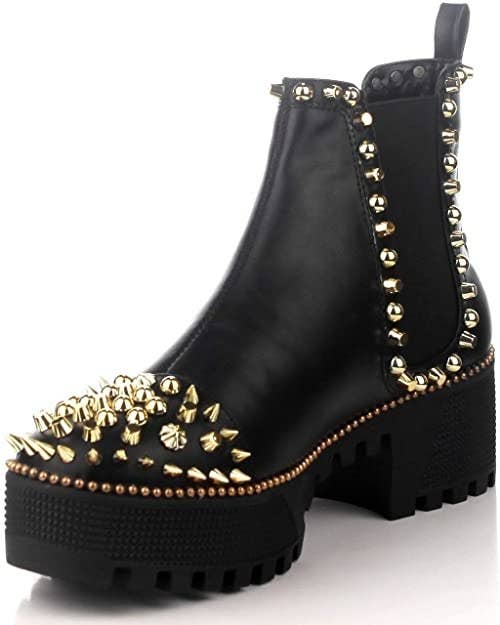 The black platform boots with gold studs on display