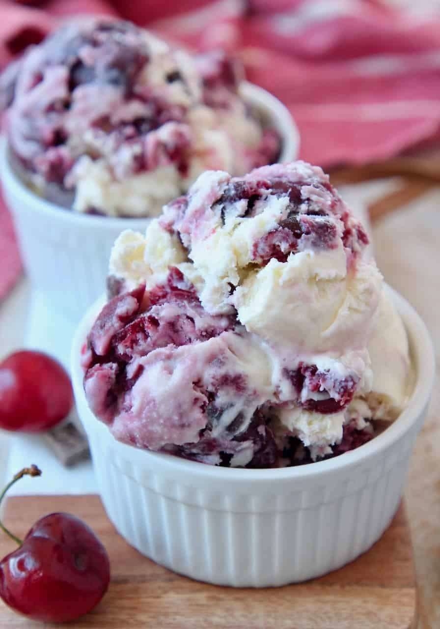 Scoops of Cherry Garcia Ice Cream in a white bowl with cherries.