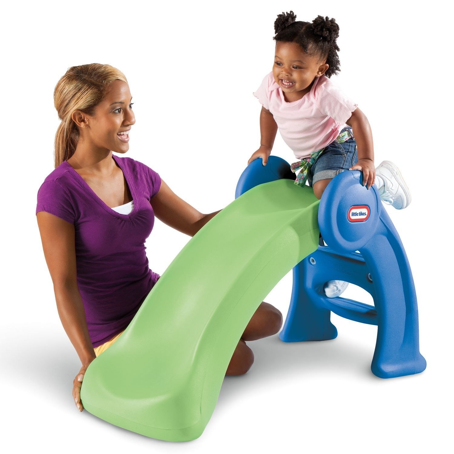 toddler playing on blue and green slide