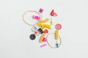 A cluster of objects such as paper clips thumb tacks etc