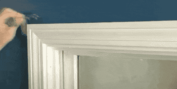 a gif of someone installing the brackets over a window