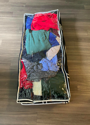A customer review photo of the storage bag filled with their clothes