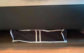 A customer review photo of the storage bag under their bed