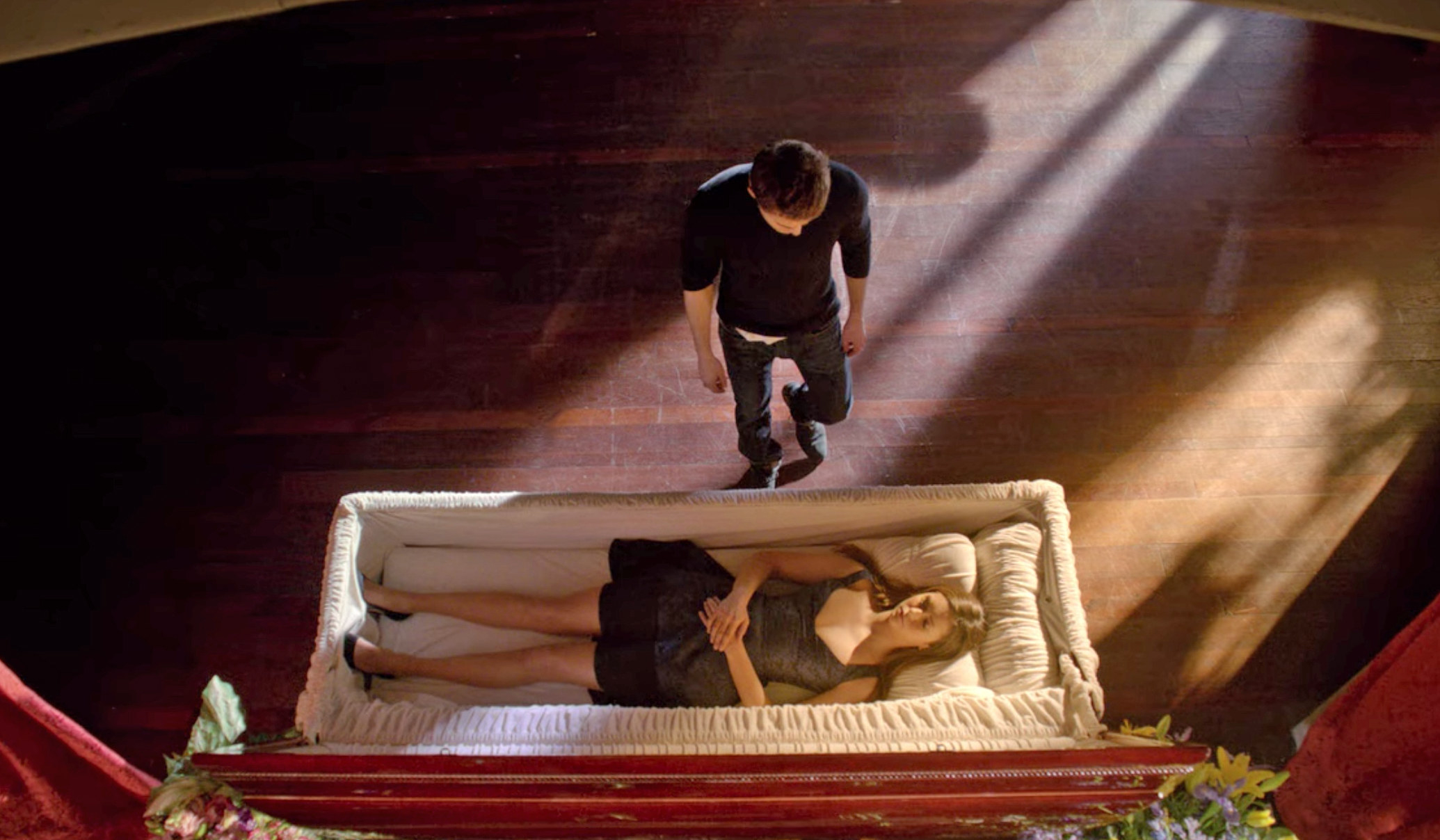 Stefan looking at Elena&#x27;s lifeless body in a coffin