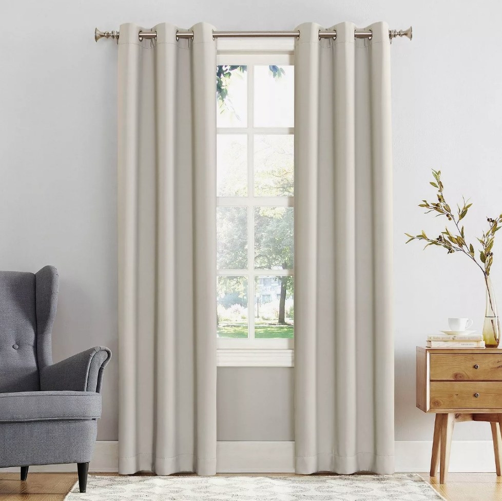 two beige curtain panels on a window
