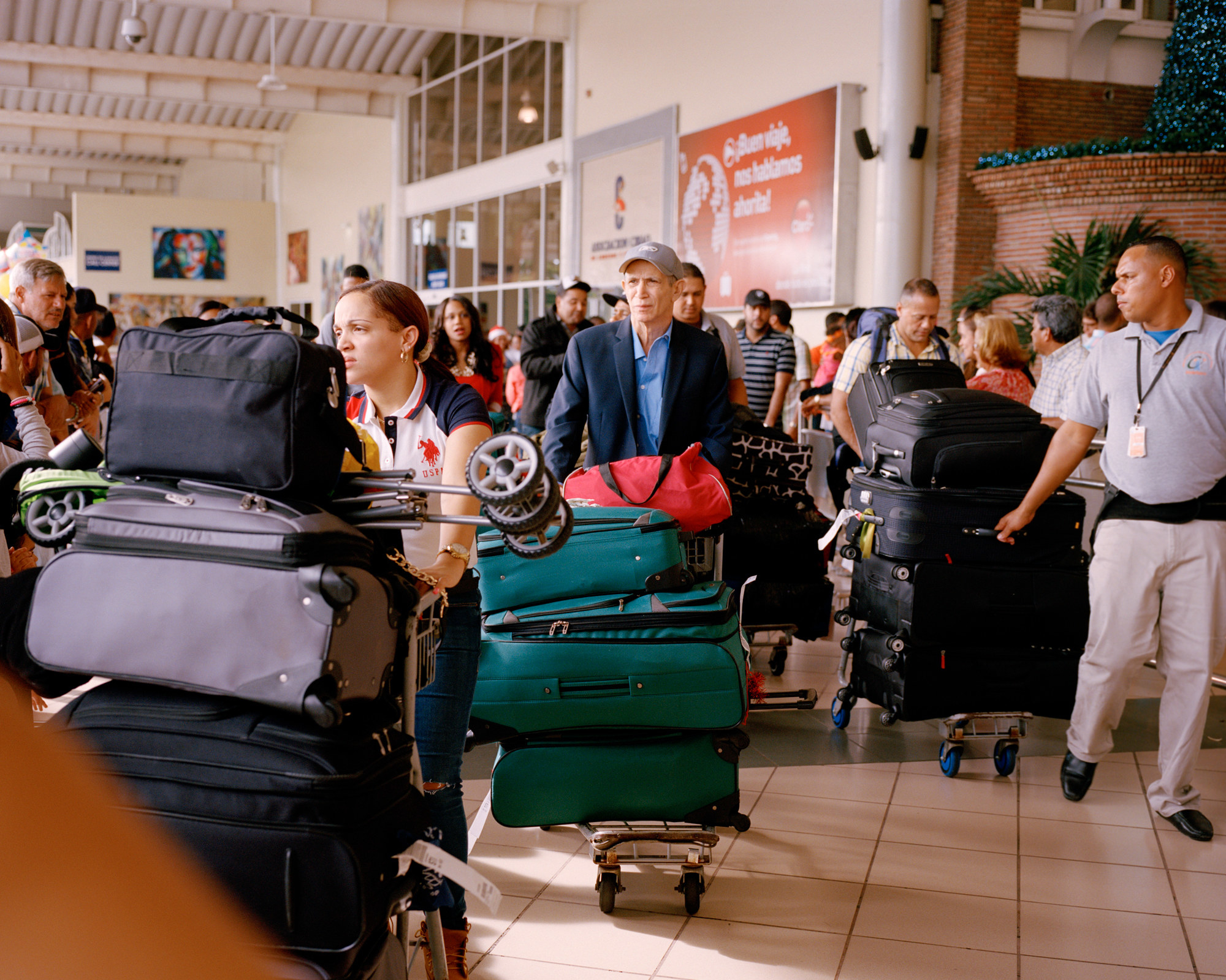 The photographer&#x27;s father with a large baggage cart in an airport