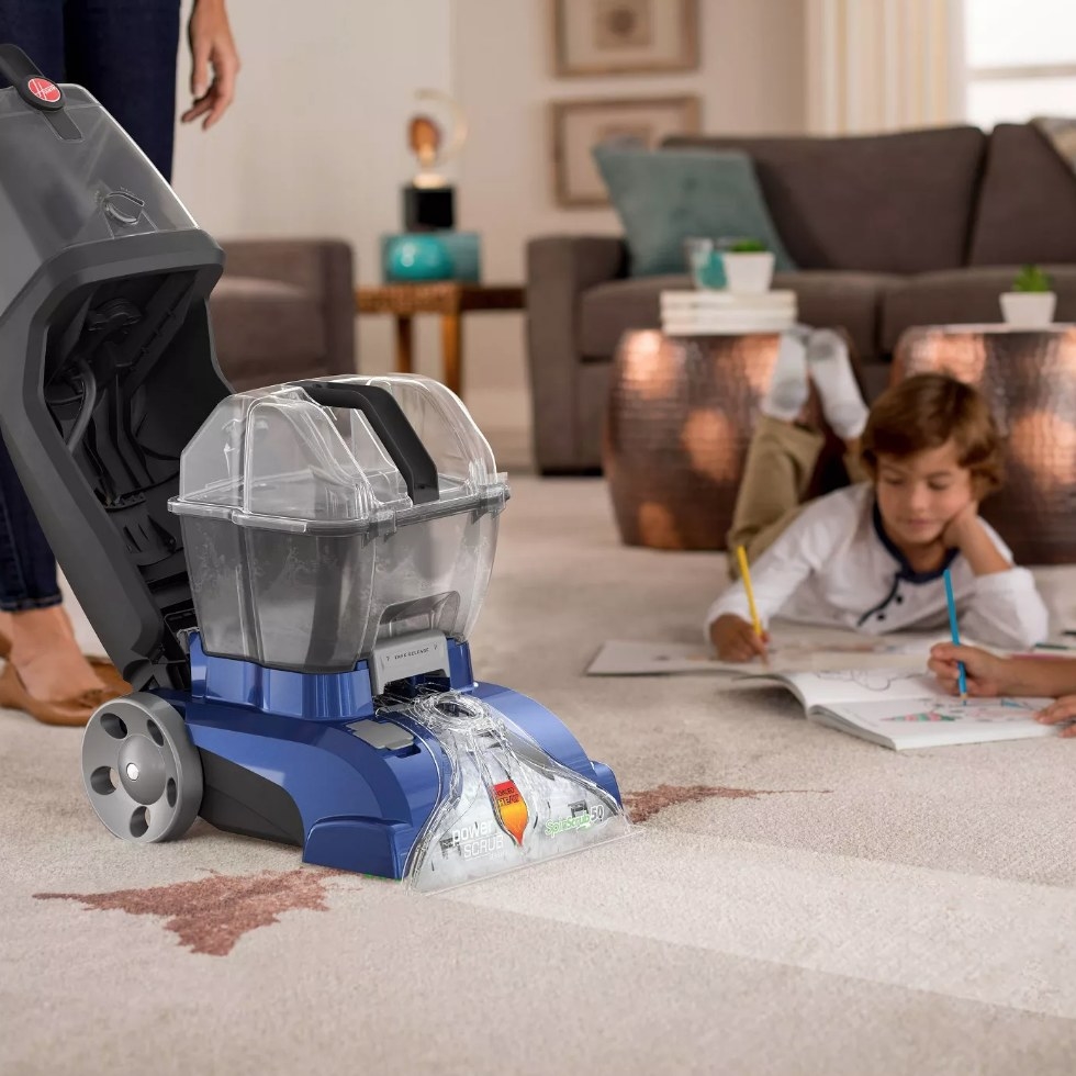 Hoover Carpet Cleaner removing stain on carpet while children draw in the background 