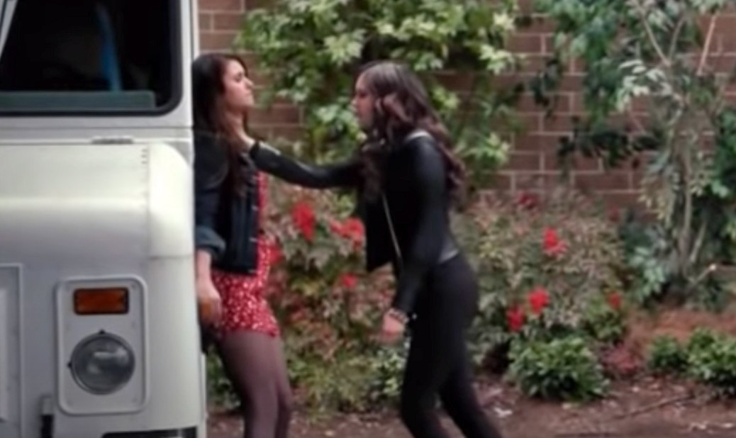 Katherine pushes Elena up against a truck and places her hand around her neck