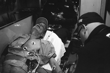 The photographer's father looking unconscious in an ambulance 
