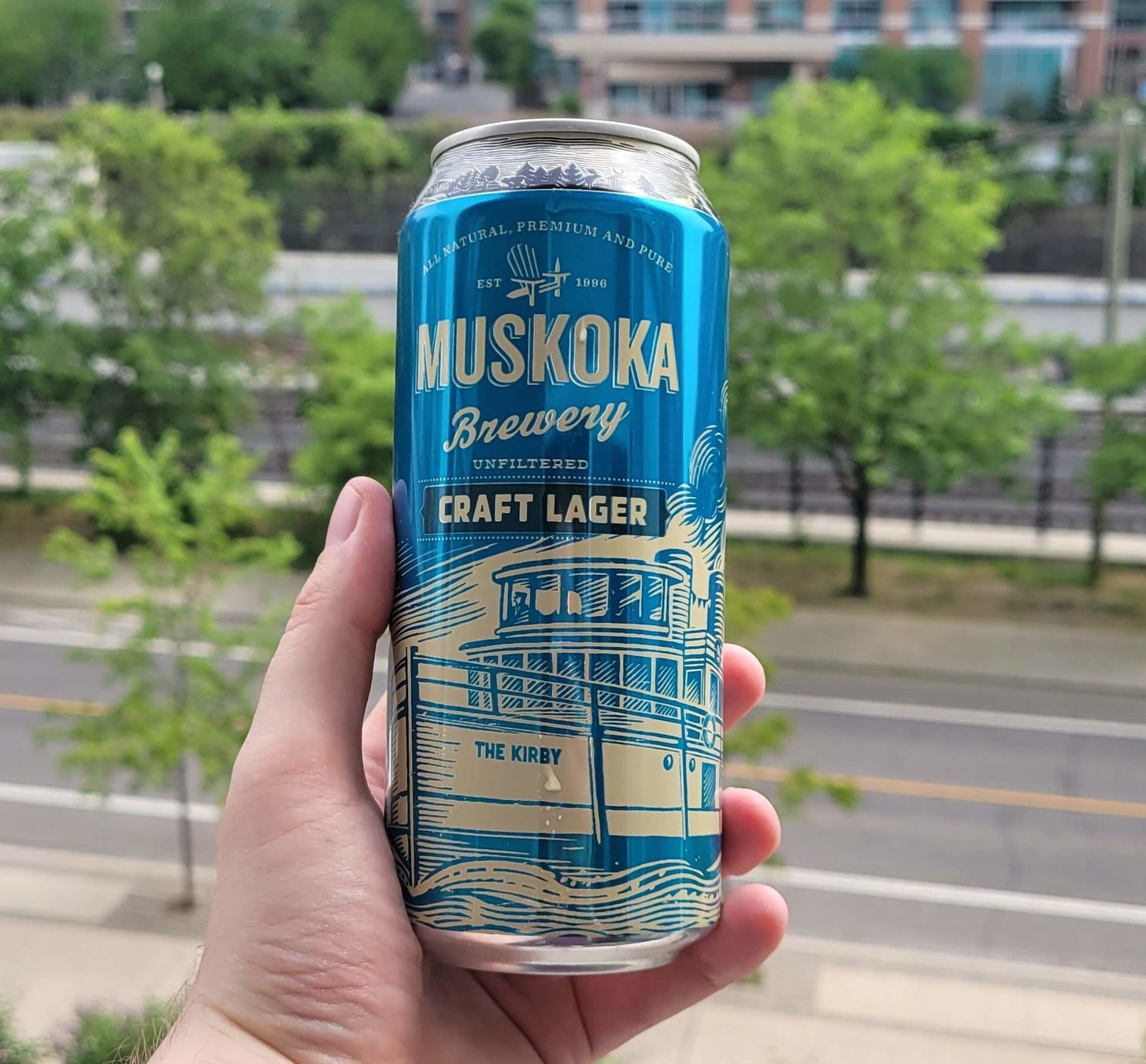 A can of Muskoka Craft Lager being held in a hand.