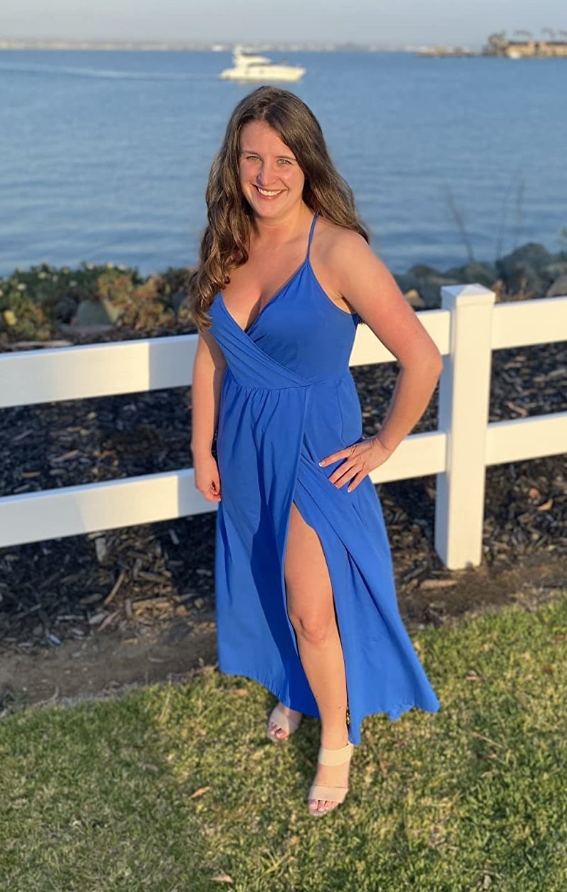 a reviewer wearing the dress in blue