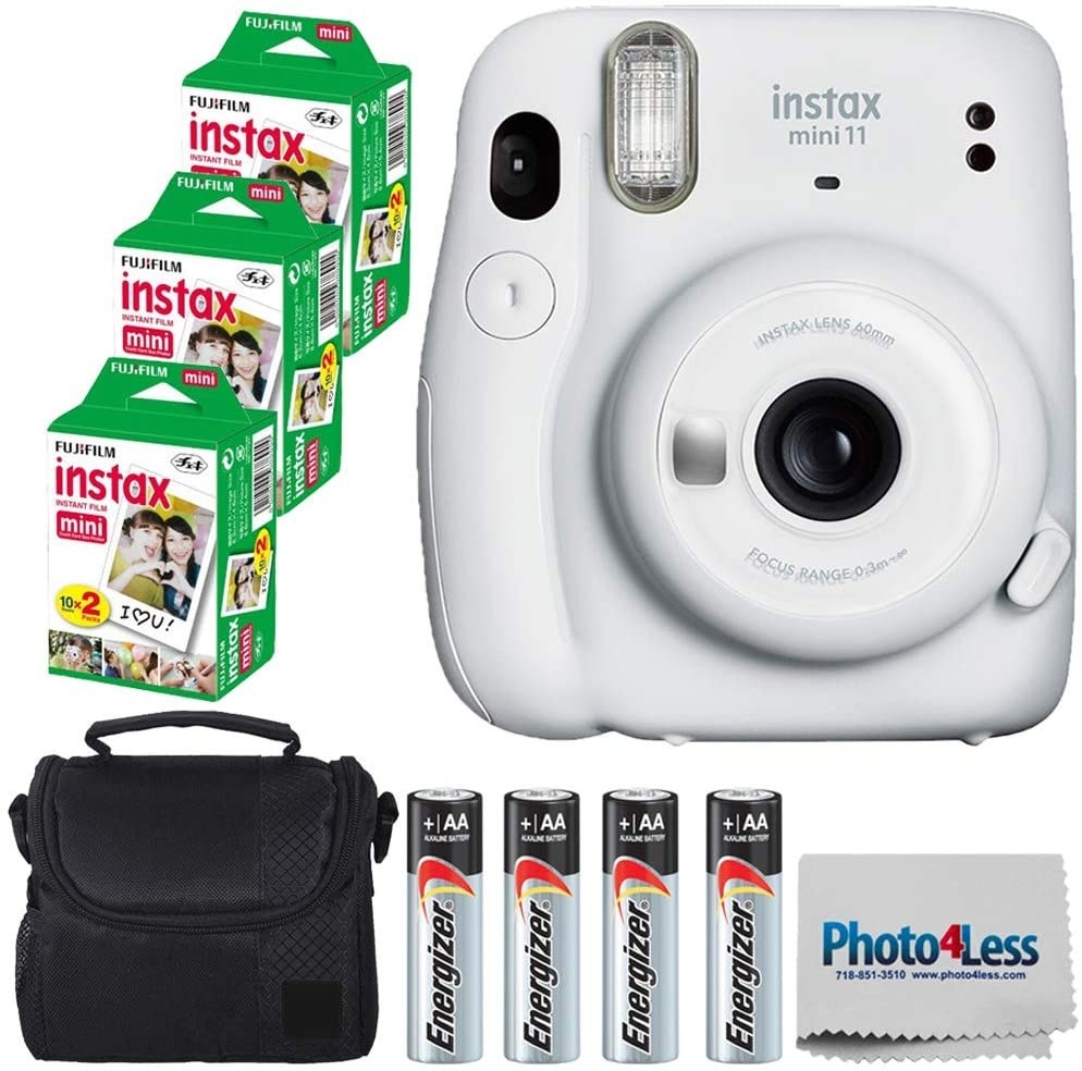 White camera with complete package of film, batteries and bag