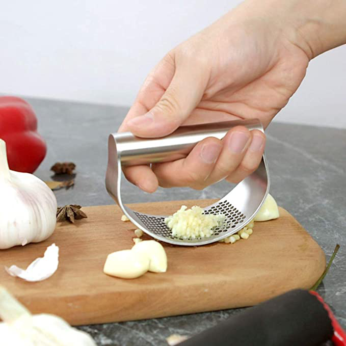 Garlic minced on a wooden board.