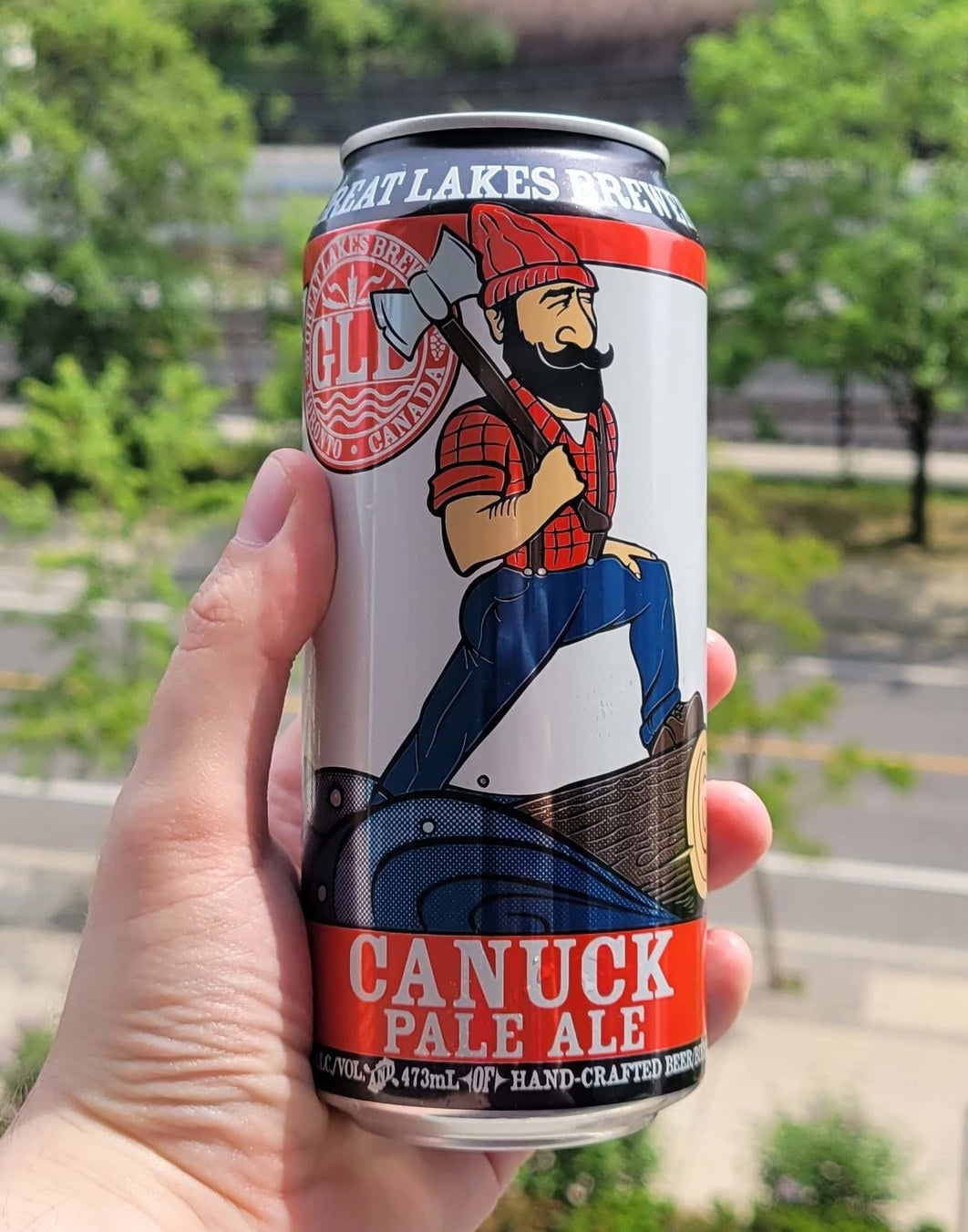 A can of Canuck Pale Ale being held in a hand.