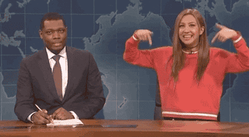 An animated GIF of Weekend Update from SNL of a girl pointing down.