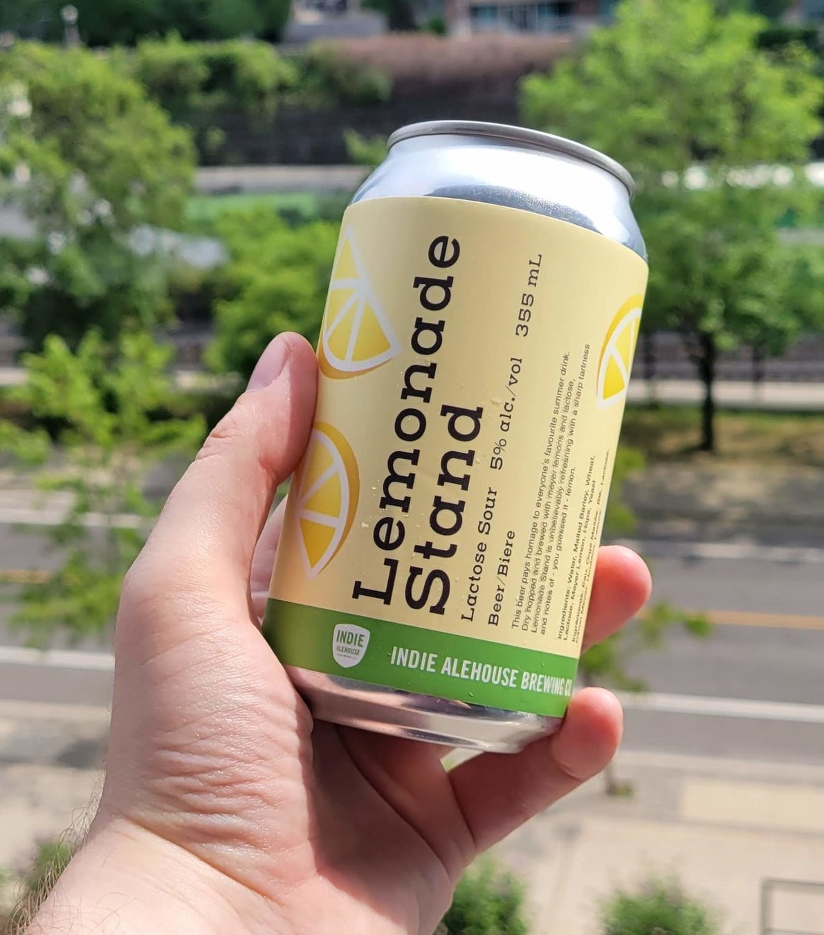 A can of Lemonade Stand being held in a hand.