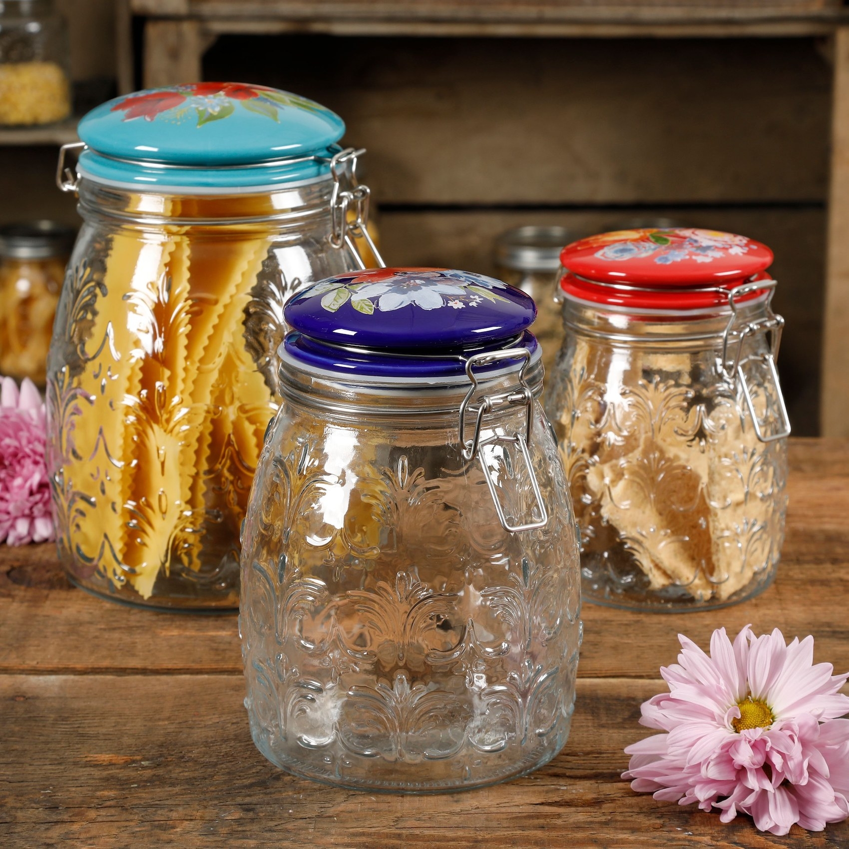 The glass jars with colorful clamp tops storing dry pasta
