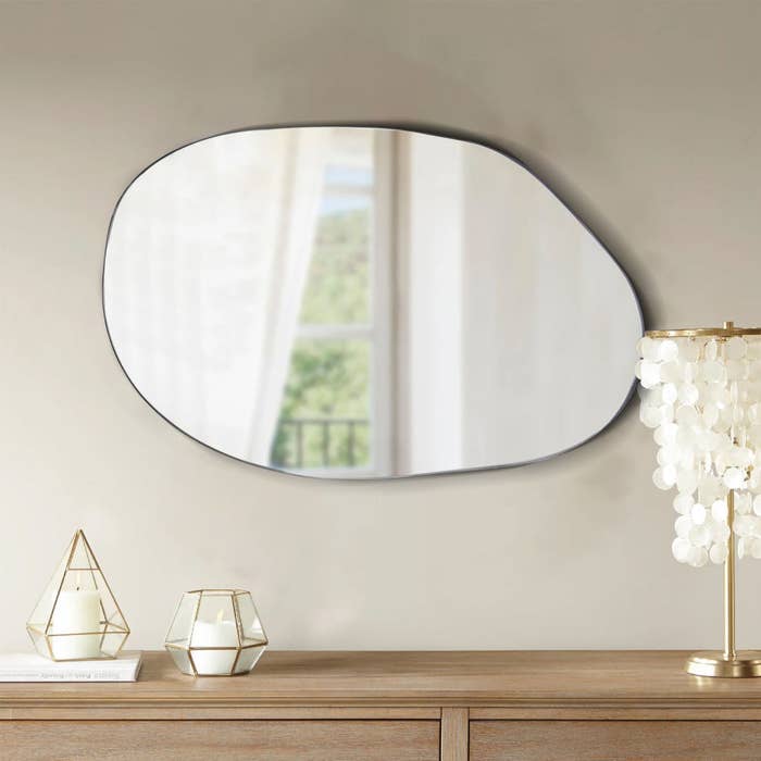 an asymmetrical mirror over a table