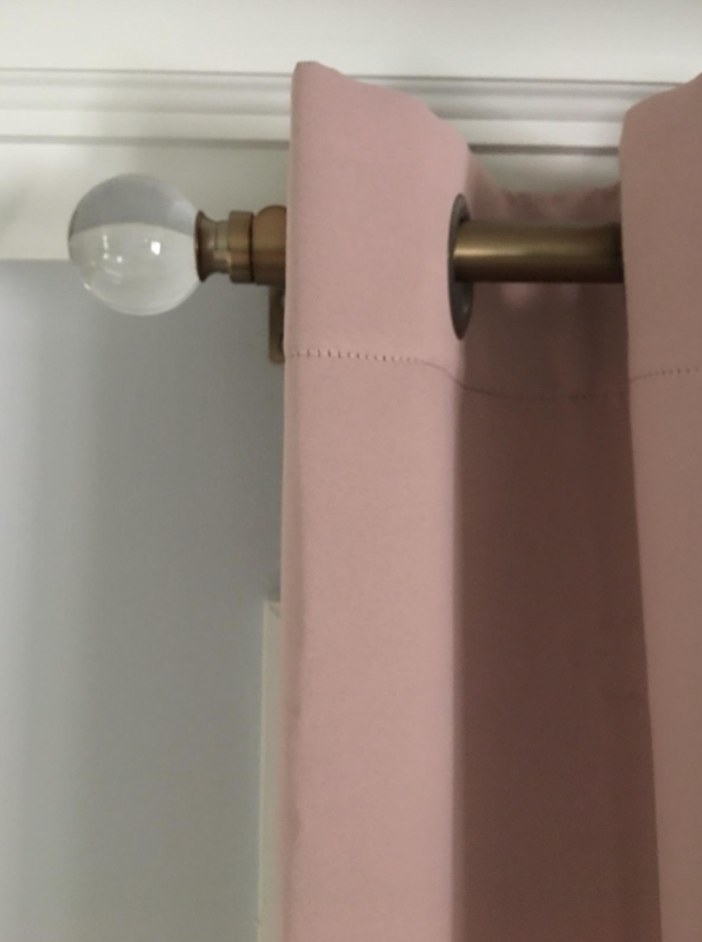 Brass curtain rod with pale pink curtain