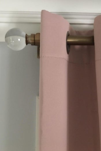 Brass curtain rod with pale pink curtain