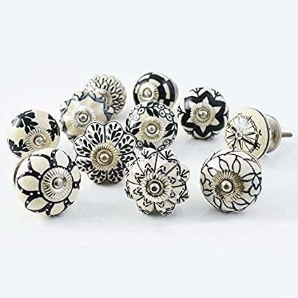 Black and white printed door knobs with traditional floral designs.