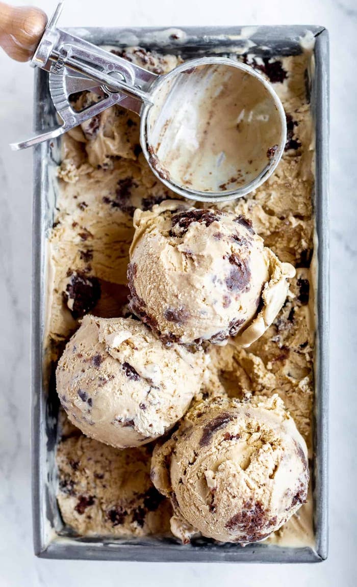 Scoops of coffee brownie ice cream in a metal tin